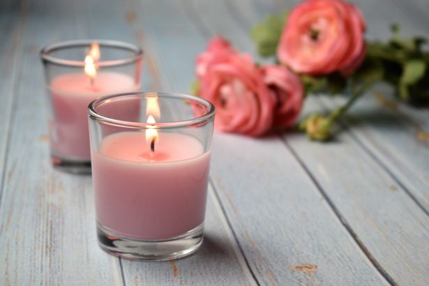 شموع وردية معطرة مع الزهور