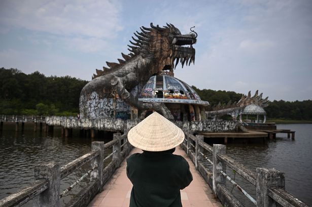 تُظهر هذه الصورة التي التقطت في 27 أبريل 2019 زائرًا يلتقط صورة لهيكل Derelict Dragon تحت عنوان Ho Thuy Tien Waterpark المهجورة الآن في مدينة Hue الفيتنامية الوسطى. -أصبحت الحديقة المائية المهجورة المغطاة بالجرافيتي بمثابة جذب مسار في العاصمة الإمبراطورية السابقة في فيتنام ، مما يجذب السياح من المدينة أكثر من الزوار التقليدي الذي يجب أن يرى مثل القلعة والمقابر القديمة. (تصوير Manan Vatsyayana / AFP) (يجب أن يقرأ الائتمان الصورة Manan vatsyayana / AFP عبر Getty Images)