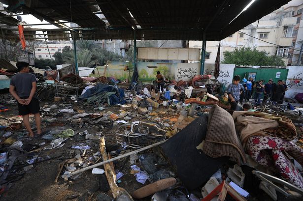 يبحث الفلسطينيون في بقايا المدرسة التي ضربت في غارة جوية إسرائيلية في 26 مايو