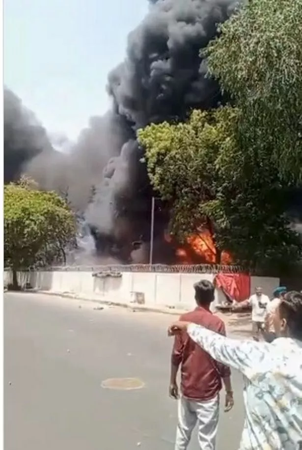 الناجي فيشواشكومار راميش (أعلى أبيض في الخلف)) مسافة مع الطائرة على بعد النار في المسافة 