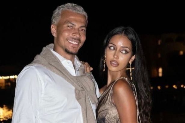 Dele Alli ، في قميص أبيض وسروال بني ، و Cindy Kimberly ، في فستان بني.