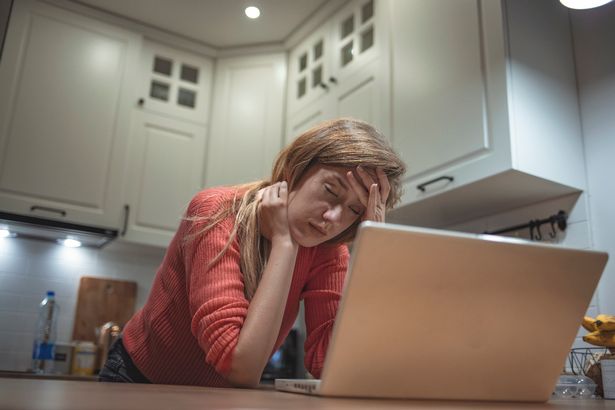 امرأة متوترة على الكمبيوتر المحمول