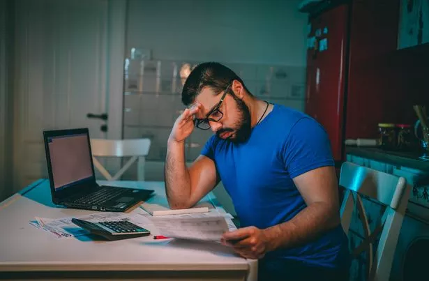 شاب محبط يمتلك صداع أثناء مروره من خلال الشؤون المالية في المساء