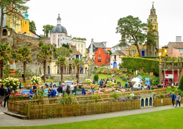 Portmeirion ، ويلز - 6 سبتمبر 2014: Portmeirion Central Piazza. العديد من الأشخاص موجودون - بعض السياح ، وبعضهم من الحاضرين في 