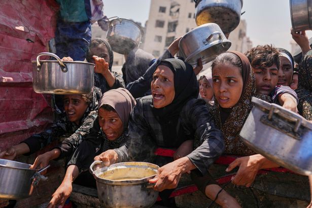 يكافح الفلسطينيون من أجل التبرع بالطعام في مطبخ مجتمعي في مدينة غزة ، قطاع غزة الشمالي ، الاثنين ، 4 أغسطس ، 2025. (AP Photo/Jehad Alshrafi)
