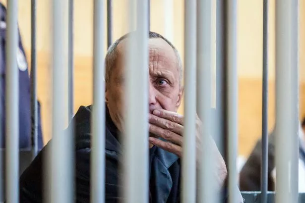يجلس Popkov داخل قفص المدعى عليهم خلال جلسة استماع في المحكمة في Irkutsk في ديسمبر 2018