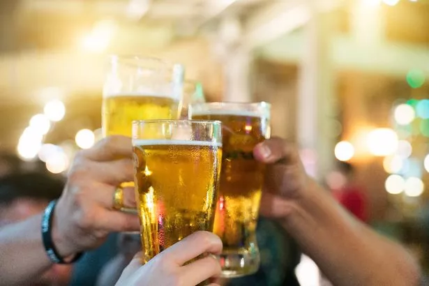 مجموعة من الأصدقاء السعداء يشربون البيرة والخبز المحمص في مطعم Brewery Bar