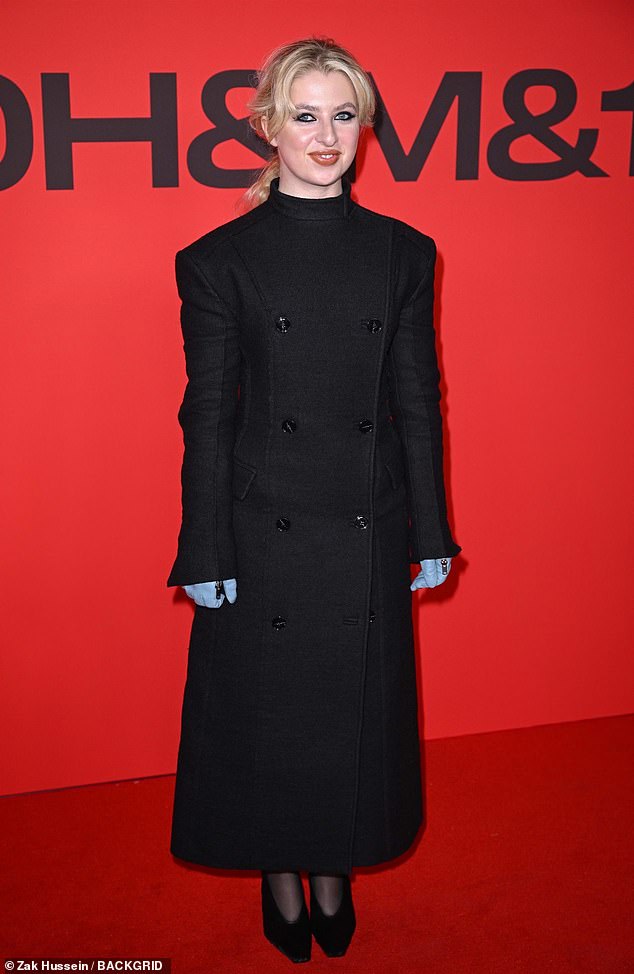 بدت Anais أنيقة وهي ترتدي فستانًا رائعًا على طراز المعطف عالي العنق ، ويتميز بوسادات الكتف