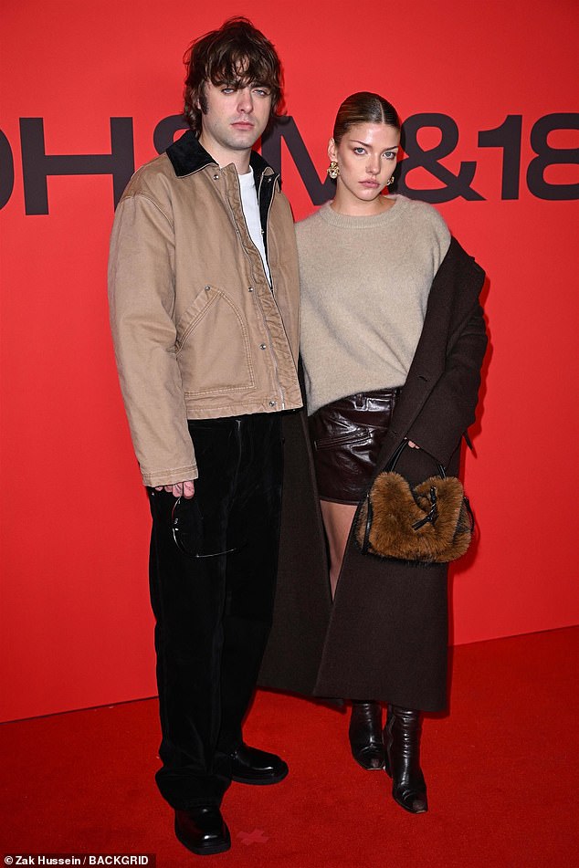 في هذه الأثناء اختارت صديقته إيزي نظام ألوان عاري مماثل لأنها ترتدي سترة بيج خفيفة مع تنورة براءات براءة حمراء داكنة ، بالإضافة إلى معطف بني ضخم