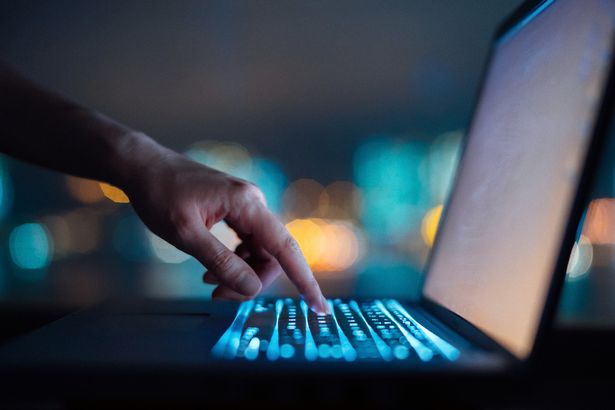 تكتب امرأة على الكمبيوتر المحمول