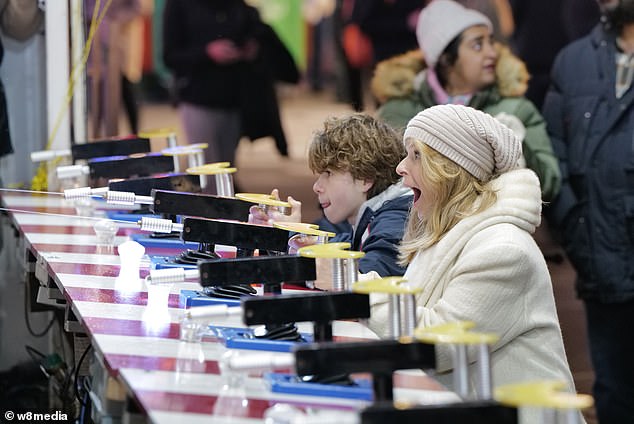 كان شقيقها بيلي يرتدي معطفًا منتفخًا أزرق اللون مع سترة رمادية اللون عندما انضم إلى والدته في لعبة ليزر