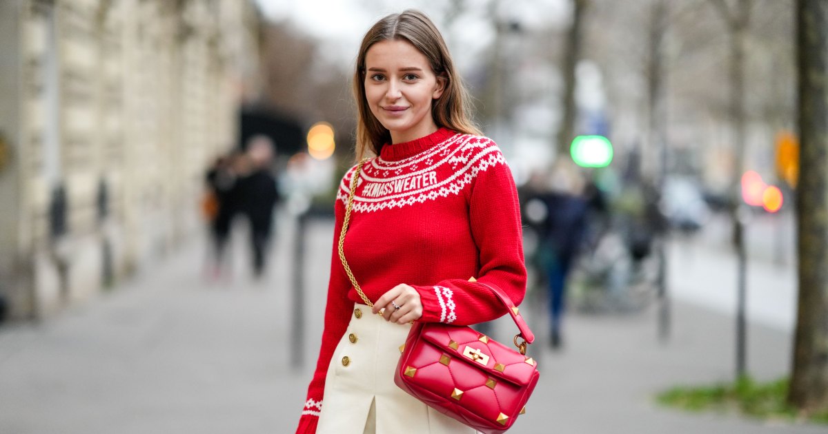 ترتدي ديان باتوكينا بلوفرًا من الصوف باللون الأحمر مع الأبيض المطرز بنمط عيد الميلاد، وسروالًا قصيرًا بطيات من الصوف / التويد الأبيض، وخواتم، وحقيبة يد جلدية مبطنة حمراء لامعة ومرصعة بمسامير / مرصعة من فالنتينو، خلال جلسة تصوير أزياء على طراز الشارع، في 15 ديسمبر 2021 في باريس، فرنسا.