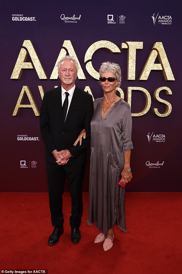 وظهرت الممثلة متألقة أثناء التقاطها الصور مع زوجها برايان، وبدت أنيقة في فستان رمادي ضيق وقلادة ذهبية ونظارات شمسية وقحة.